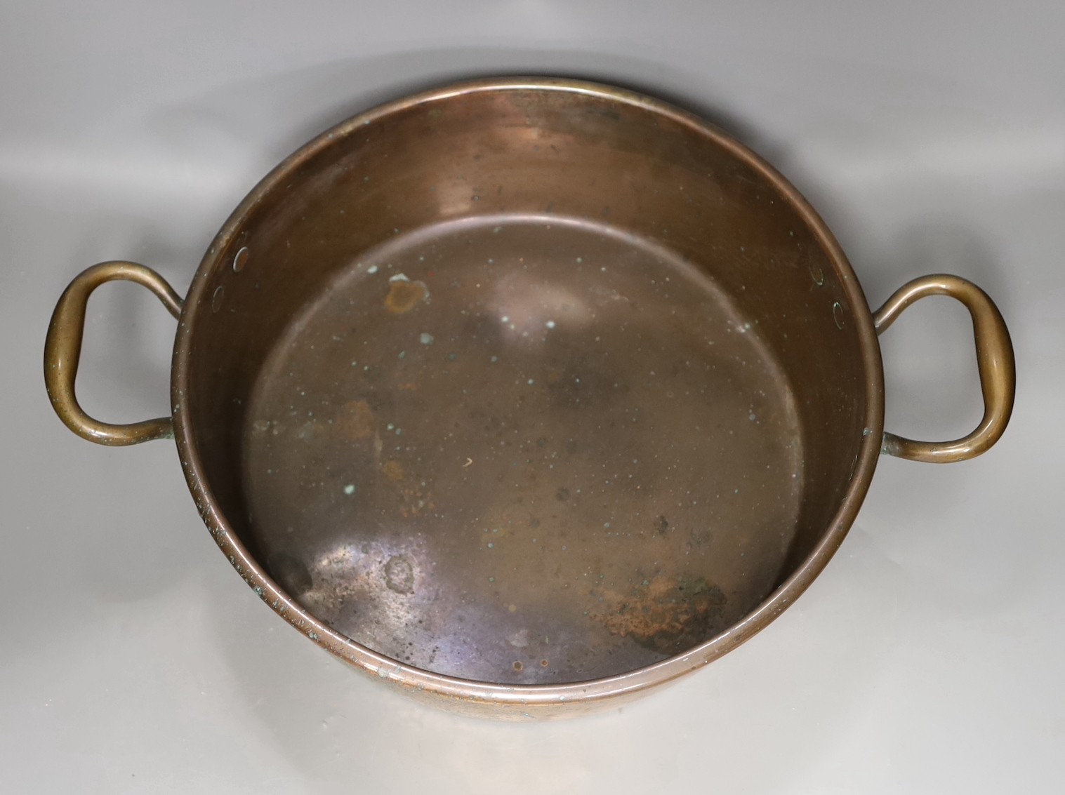 A 19th century copper two handled preserving pan, 51cms handle to handle